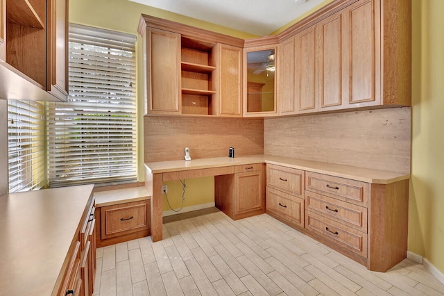 kitchen featuring built in desk and decorative backsplash