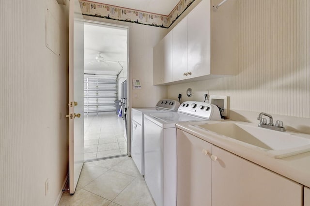 laundry area with cabinets, sink, light tile patterned floors, washer and clothes dryer, and ceiling fan