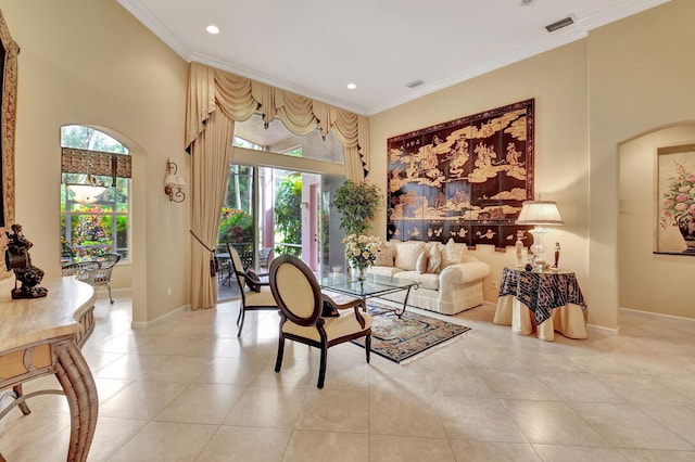 tiled living room with a towering ceiling and ornamental molding