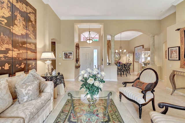 living room with a notable chandelier, light tile patterned flooring, crown molding, and decorative columns