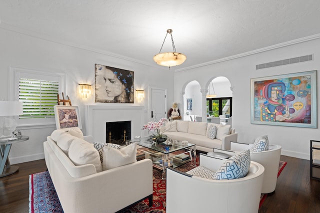 living room featuring dark wood-type flooring and crown molding