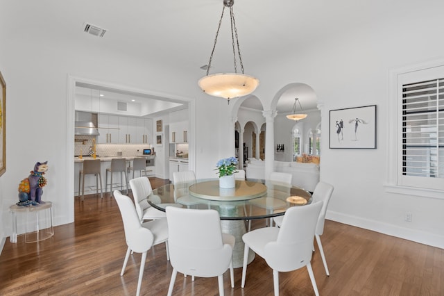 dining space featuring dark wood-type flooring