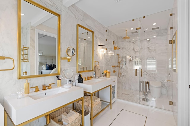 bathroom featuring a shower with door, tile walls, vanity, and tile patterned floors