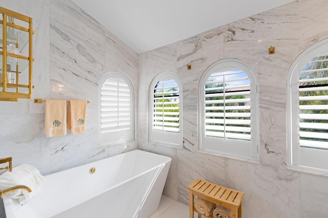 bathroom featuring tile walls and a washtub