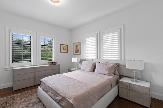 bedroom with dark hardwood / wood-style flooring