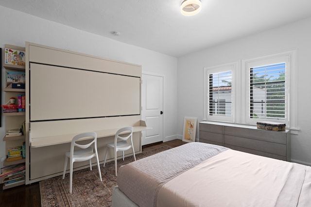 bedroom with dark hardwood / wood-style flooring