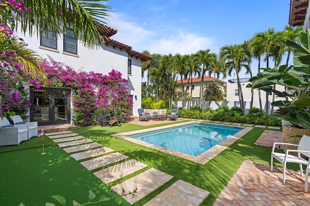 view of pool featuring a patio and a lawn