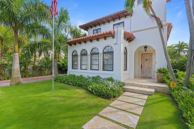 mediterranean / spanish-style home featuring a front lawn