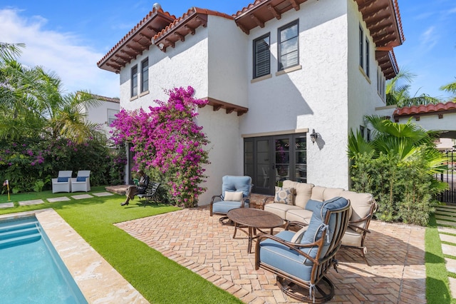 back of house with a patio area, a yard, and an outdoor hangout area