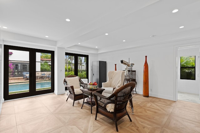 living area featuring french doors and light parquet flooring