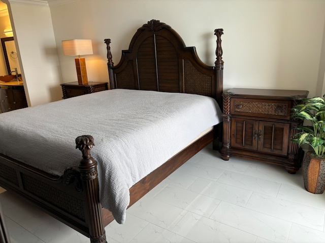 bedroom with ensuite bathroom and ornamental molding