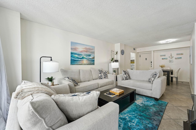 tiled living room featuring a textured ceiling