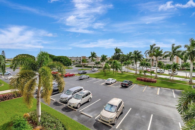 view of parking / parking lot with a yard