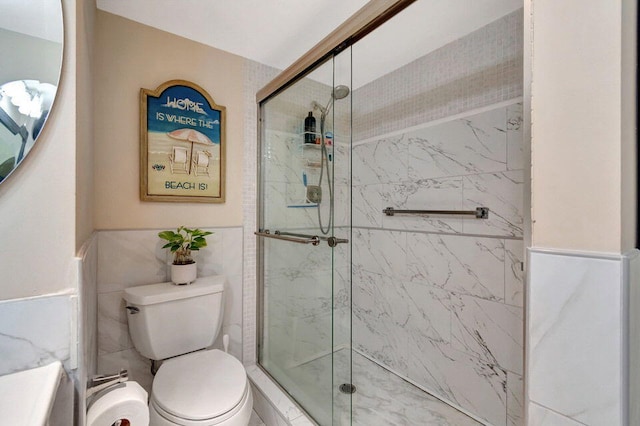 bathroom featuring walk in shower, tile walls, and toilet