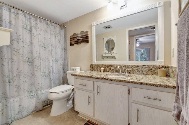 bathroom featuring toilet, a shower with curtain, vanity, and tile patterned floors