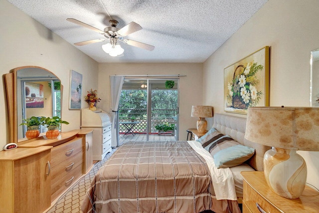 bedroom featuring ceiling fan, access to exterior, and a textured ceiling