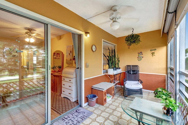 sunroom featuring ceiling fan