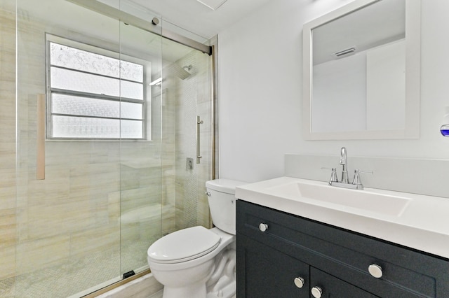 bathroom featuring walk in shower, vanity, and toilet