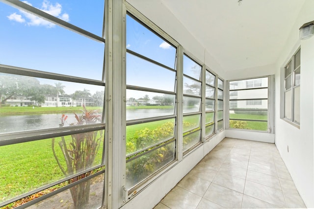 unfurnished sunroom with a water view