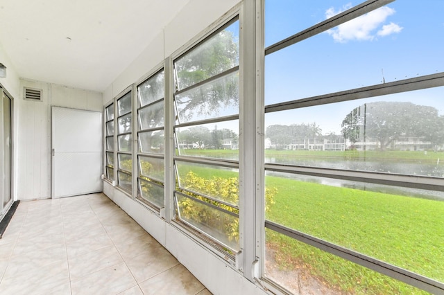 unfurnished sunroom with a water view