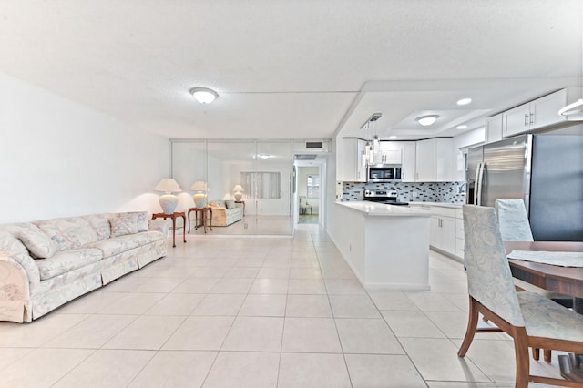 tiled living room with a textured ceiling