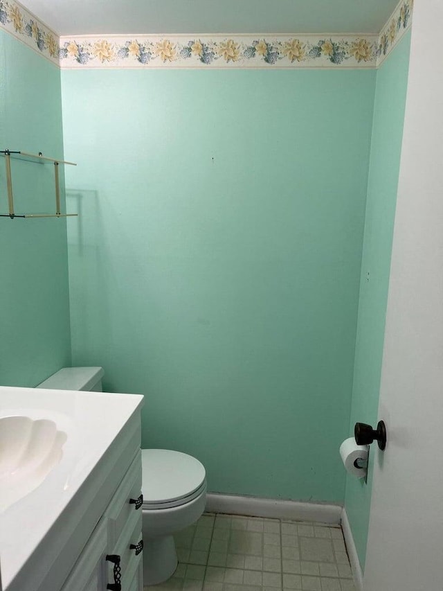 bathroom featuring tile patterned floors, vanity, and toilet