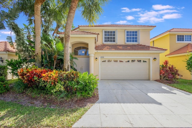 mediterranean / spanish-style house with a garage