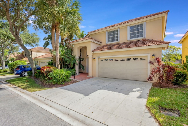 mediterranean / spanish house featuring a garage