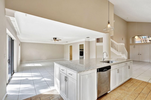 kitchen with dishwasher, sink, decorative light fixtures, light hardwood / wood-style floors, and white cabinetry