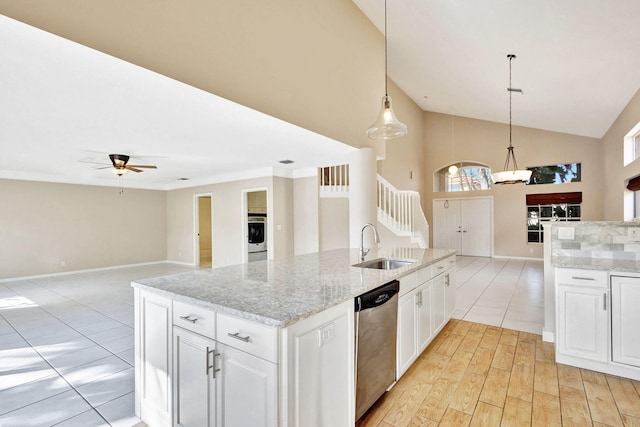 kitchen with ceiling fan, stainless steel dishwasher, decorative light fixtures, washer / dryer, and white cabinets