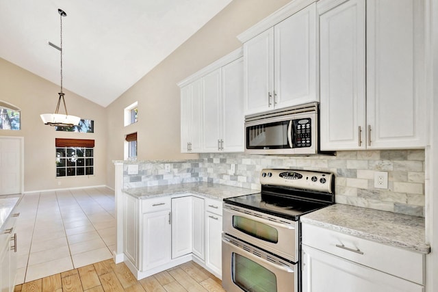 kitchen with pendant lighting, white cabinetry, lofted ceiling, and appliances with stainless steel finishes