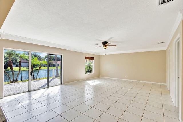 spare room with a water view, ceiling fan, ornamental molding, a textured ceiling, and light tile patterned flooring