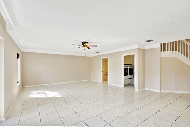 tiled spare room featuring ceiling fan, independent washer and dryer, and ornamental molding