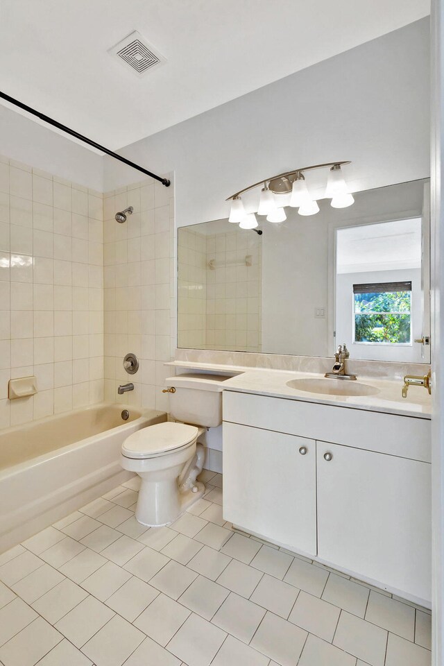 full bathroom with tile patterned floors, toilet, vanity, and tiled shower / bath