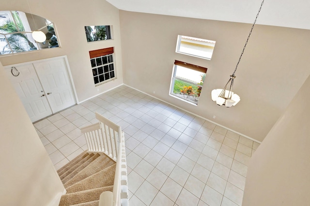 tiled foyer featuring high vaulted ceiling