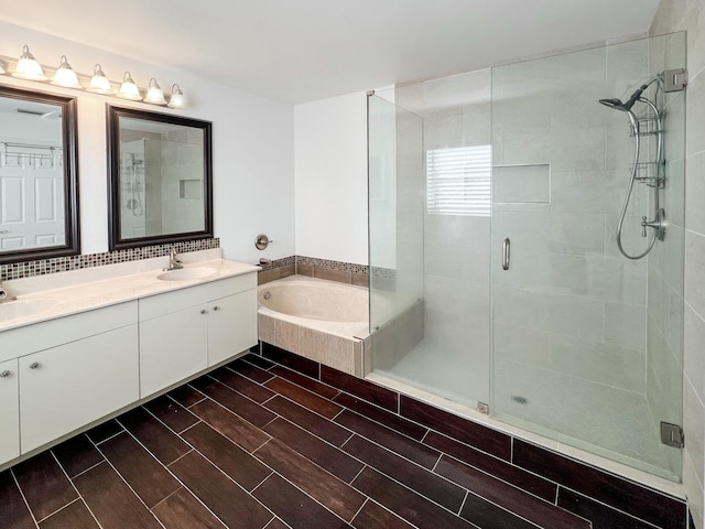 bathroom with shower with separate bathtub and vanity