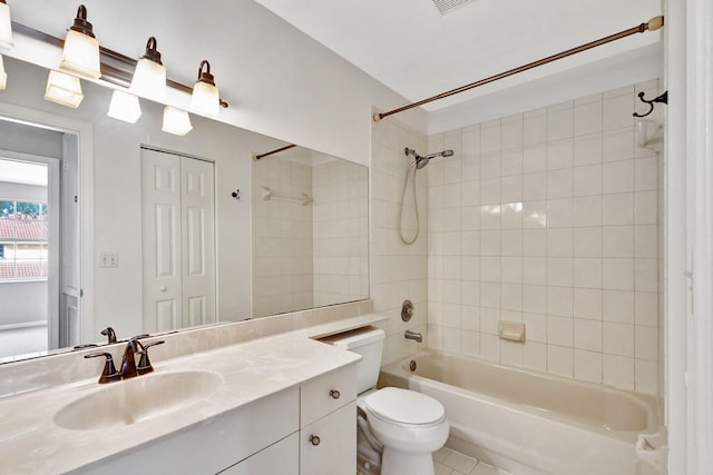 full bathroom featuring tile patterned floors, vanity, tiled shower / bath combo, and toilet