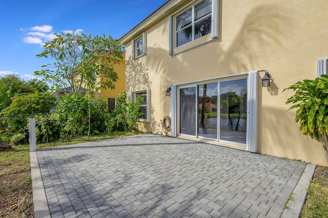 rear view of property featuring a patio