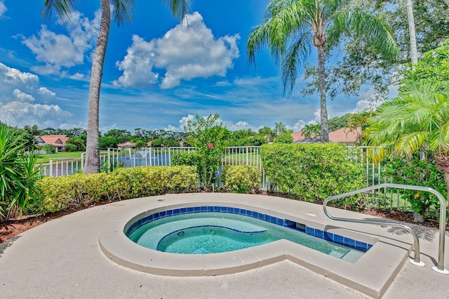 view of swimming pool with an in ground hot tub and a water view