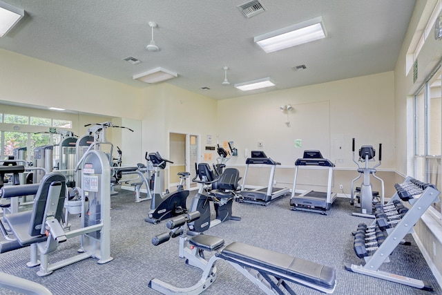 exercise room with a textured ceiling