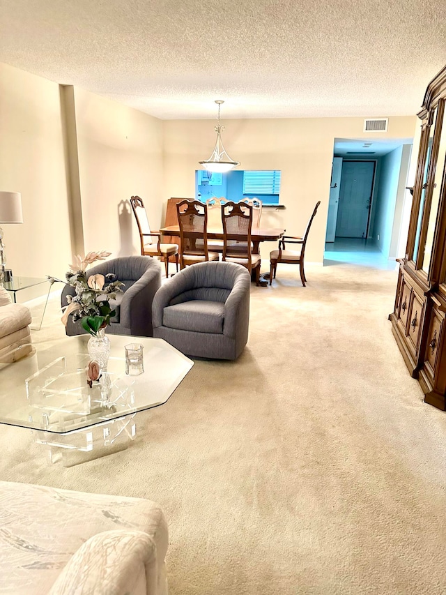 carpeted living room featuring a textured ceiling