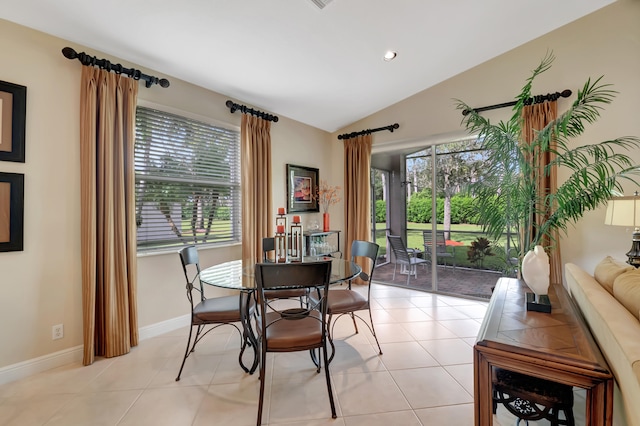 dining room featuring lofted ceiling and light tile patterned flooring