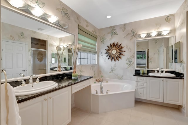 bathroom with tile patterned flooring, vanity, and separate shower and tub