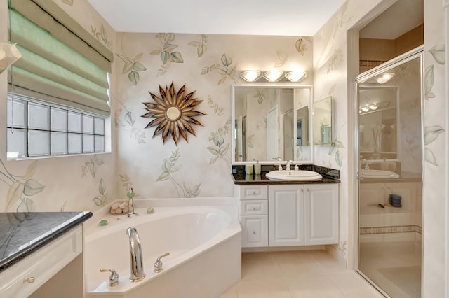 bathroom with tile patterned flooring, shower with separate bathtub, and vanity