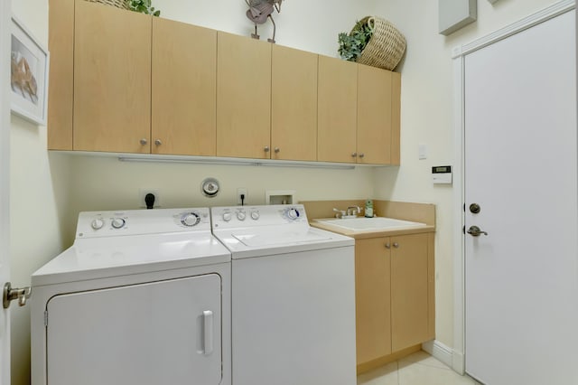 washroom with cabinets, independent washer and dryer, sink, and light tile patterned floors