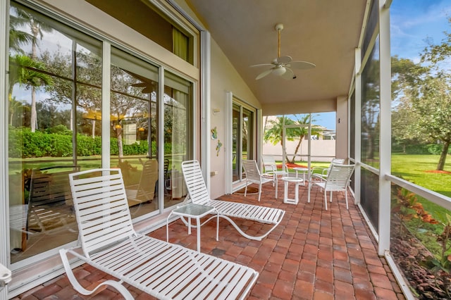 unfurnished sunroom featuring vaulted ceiling and ceiling fan