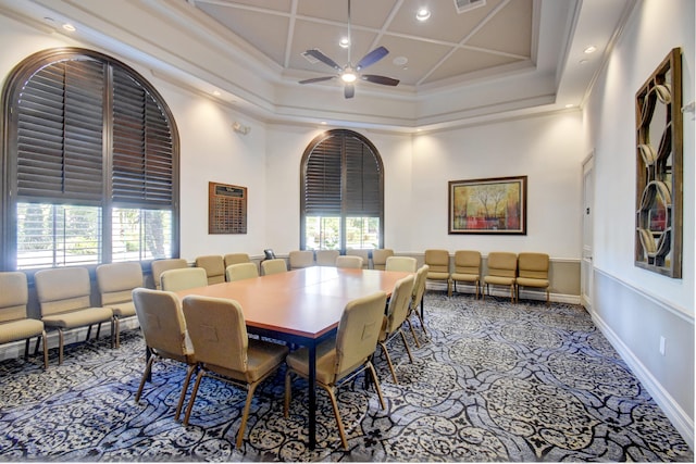 dining room featuring a towering ceiling, ceiling fan, crown molding, and coffered ceiling