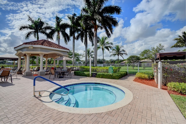 view of swimming pool with a gazebo, a patio, and a community hot tub