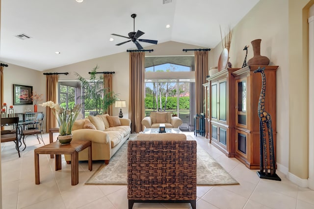 living room featuring plenty of natural light, light tile patterned floors, and lofted ceiling