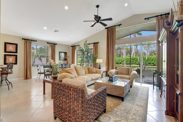 living room with ceiling fan, light tile patterned floors, and vaulted ceiling